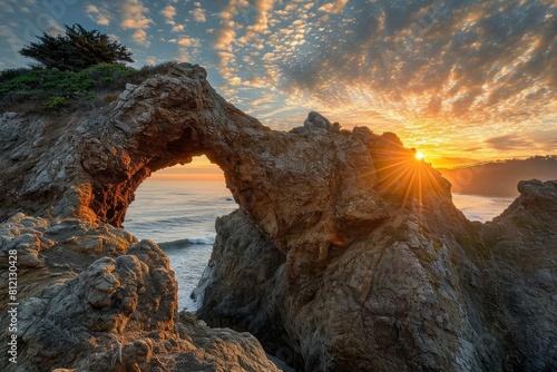 Stunning sunset view through a coastal rock arch under a dramatic cloud-filled sky