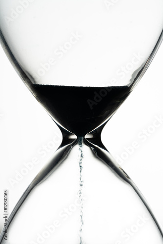 Blue sand hourglass on white background