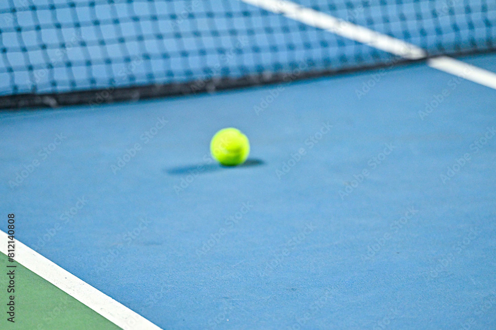 A close up photo of blue tennis court with white line