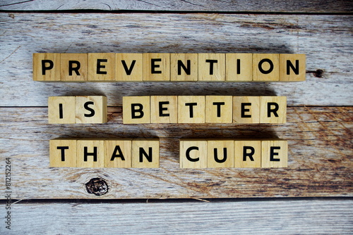 Prevention is better than cure with wooden blocks alphabet letterstop view on wooden background