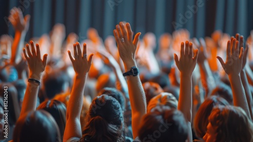 Business Professionals with Raised Hands at Conference for Voting, Volunteering, and Q&A in Corporate Event or Training Seminar