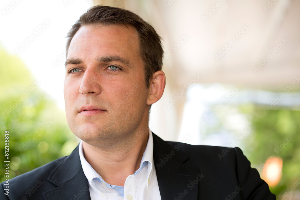 Portrait of a young business man in a dark suit and white shirt Portrait of a young business man in a dark suit and white shirt