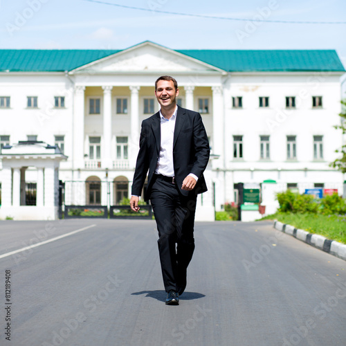 Full length portrait of a young businessman walking down the road © Andrey_Arkusha
