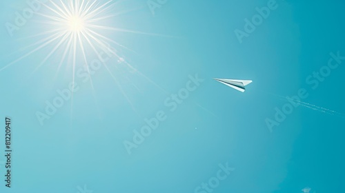Paper plane soaring in a bright sunlit sky symbolizing creativity and freedom