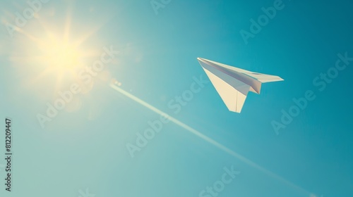 Paper plane soaring in a bright sunlit sky symbolizing creativity and freedom