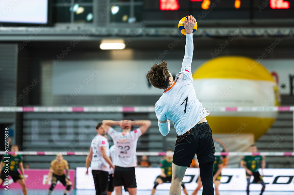 Volleyball player serves ball during the match