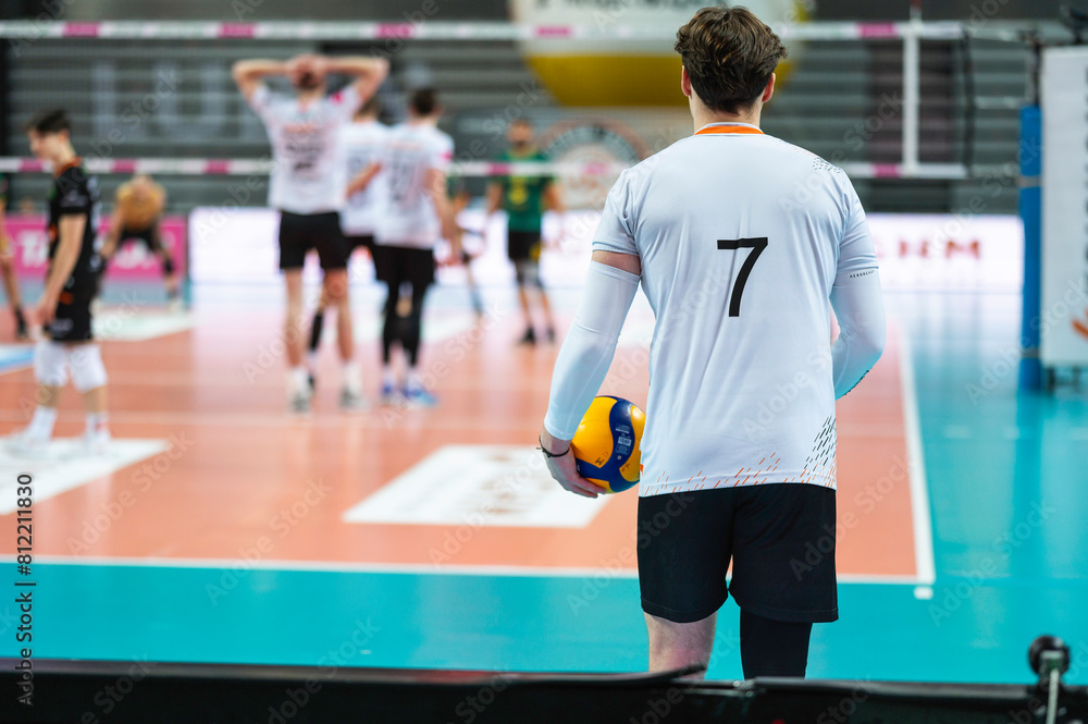 Volleyball player serves ball during the match