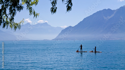 Two people paddle surfing on the Leman lake, Switzerland