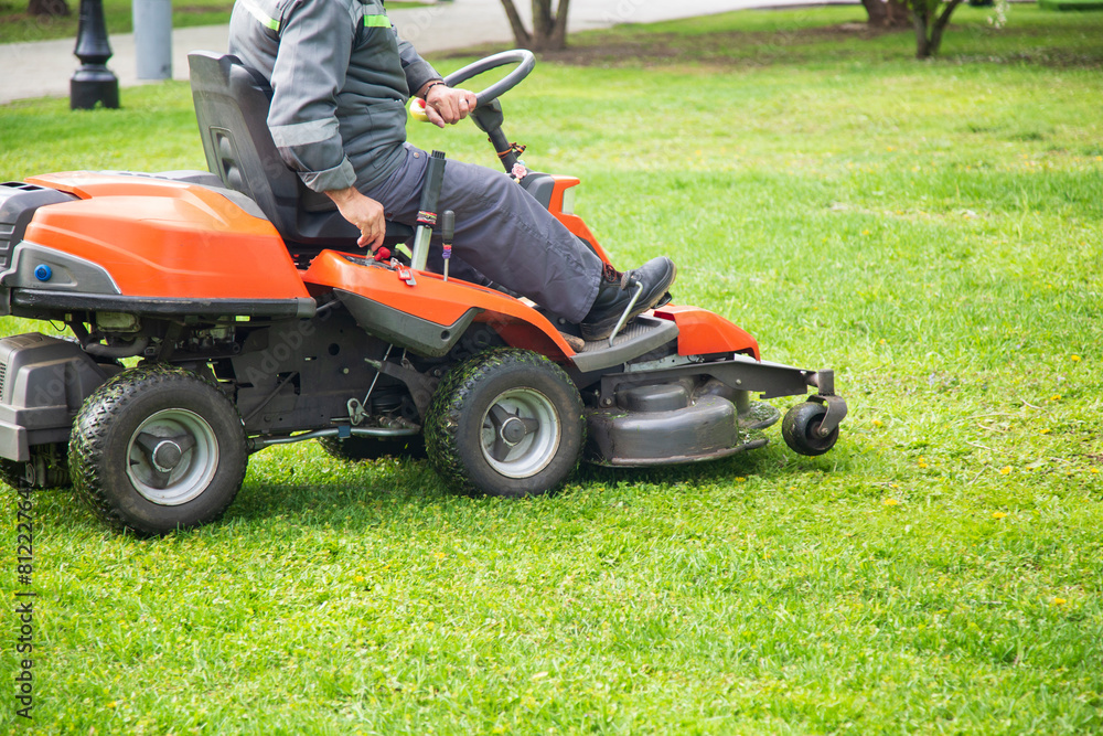 Lawn mower. Mowing the lawn by a utility worker. Lawn mower. Mowing the lawn by a utility worker.
