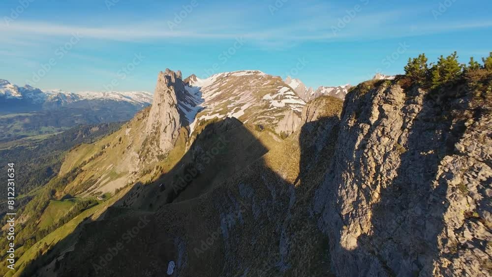 FPV drone flying close of the sharp mountain cliffs of Saxer Gap in canton of Appenzell in Switzerland, in the Alps in 4K. FPV drone flying close of the sharp mountain cliffs of Saxer Gap in canton of Appenzell in Switzerland, in the Alps in 4K.