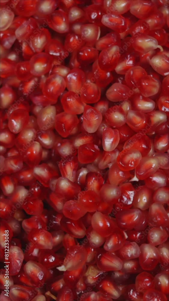 Rotating Pomegranate Seeds. Vertical.