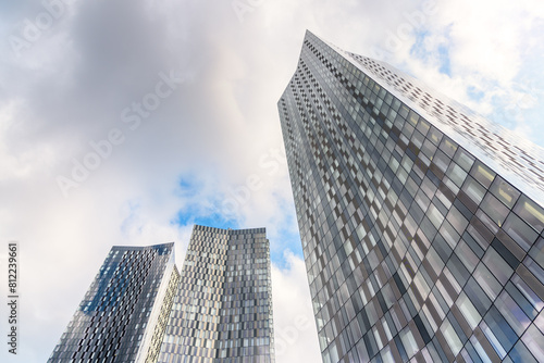 New glass residential towers under cloudy sky in summer