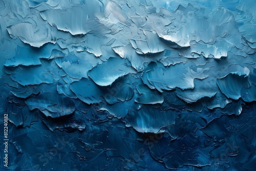 This image captures the rugged beauty of a blue-hued abstract painting, with tactile textures and deep shades giving depth and emotion