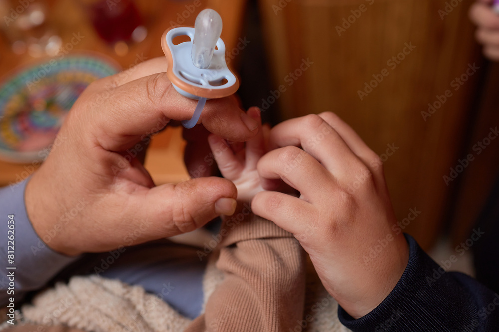 Fototapeta premium A close up of a persons thumb touching a baby tiny finger