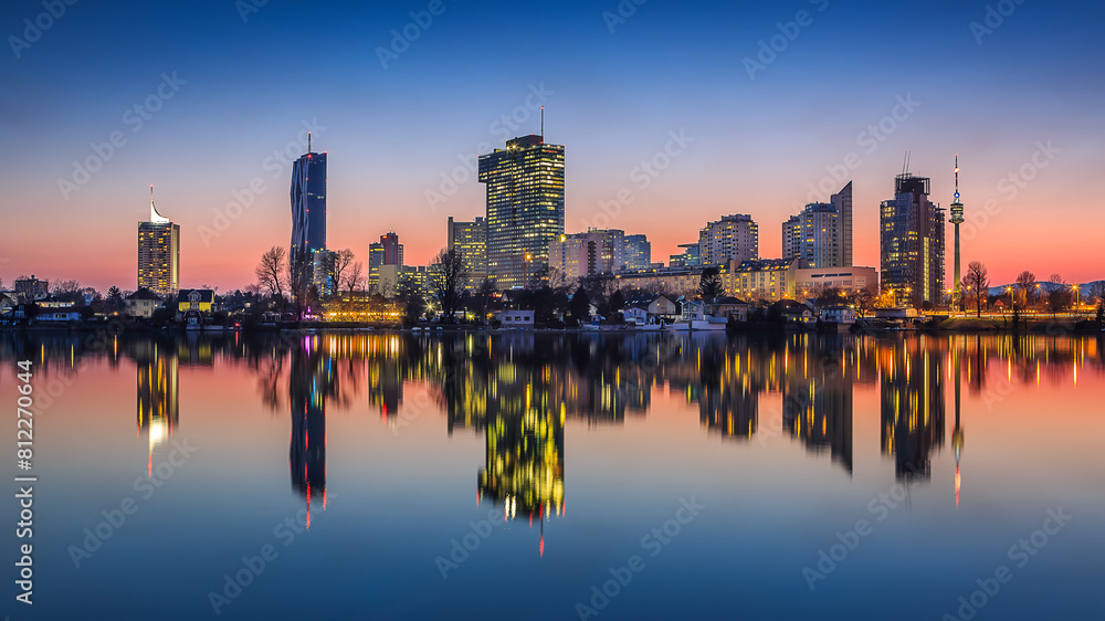 Fototapeta premium Vienna Cityscape at Dusk, Reflections on Danube with Illuminated Skyline
