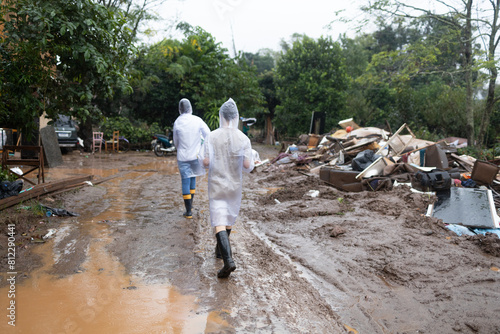 volunteers wearing raincoats taking donations to families affected by floods in southern Brazil