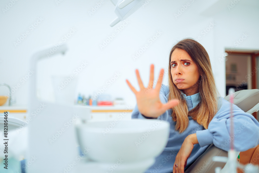Scared Patient Making Stop Gesture Sitting in the Dental Chair. Fearful woman suffering a panic attack in a dentist office
Scared Patient Making Stop Gesture Sitting in the Dental Chair. Fearful woman suffering a panic attack in a dentist office