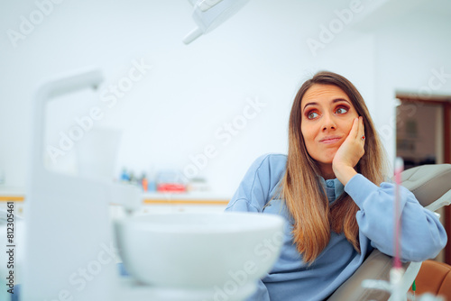 Concerned Patient Waiting for the Dentist Sitting in the Chair. Skeptical woman thinking about the medical procedure she is about to undergo 