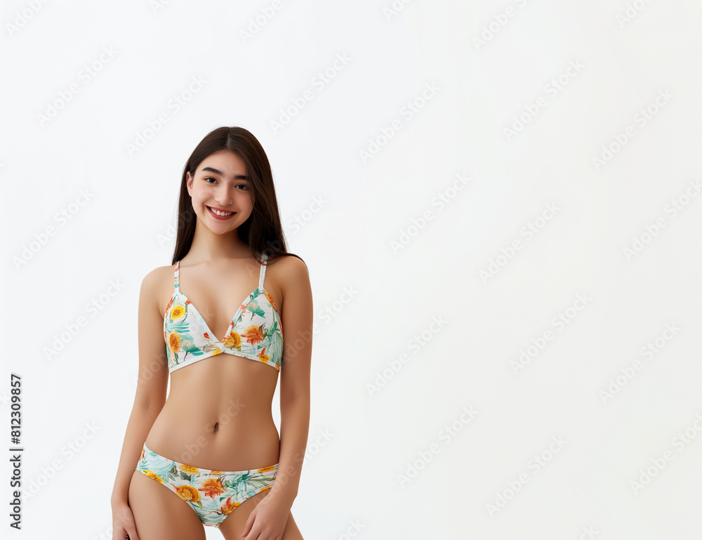 Fototapeta premium Portrait of smiling young woman in swimsuit isolated on white background, summer-themed designs, copy space