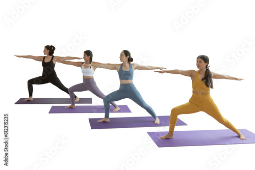 A group of women in yoga class doing the warrior pose