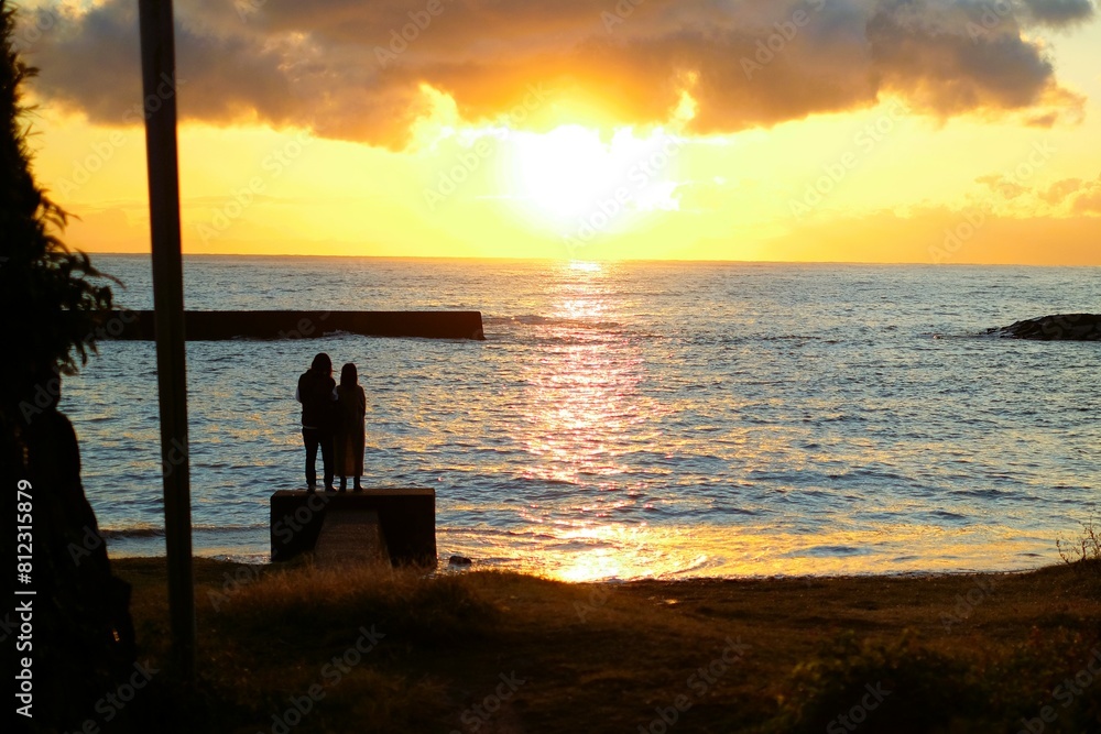 silhouette of couple on the beach at sunset silhouette of couple on the beach at sunset