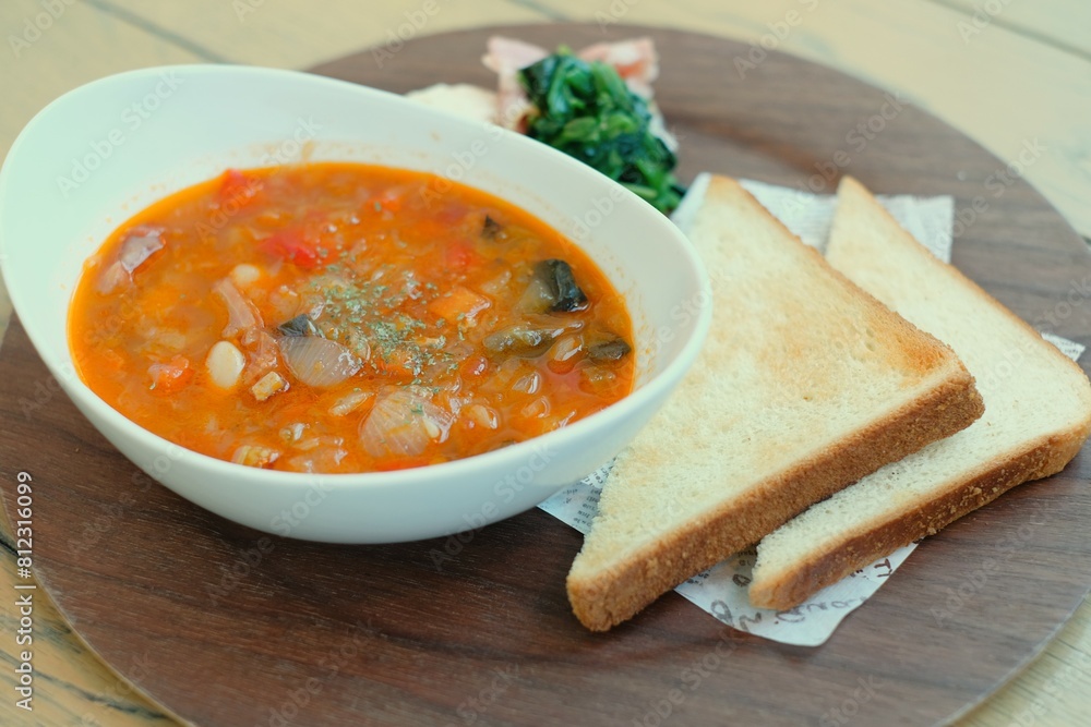 minestrone soup with toast on wooden plate minestrone soup with toast on wooden plate