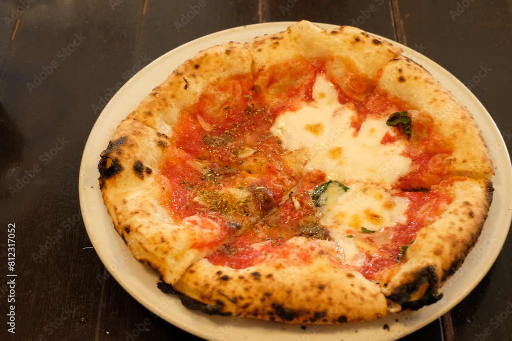 margherita and marinara pizza on a wooden table margherita and marinara pizza on a wooden table