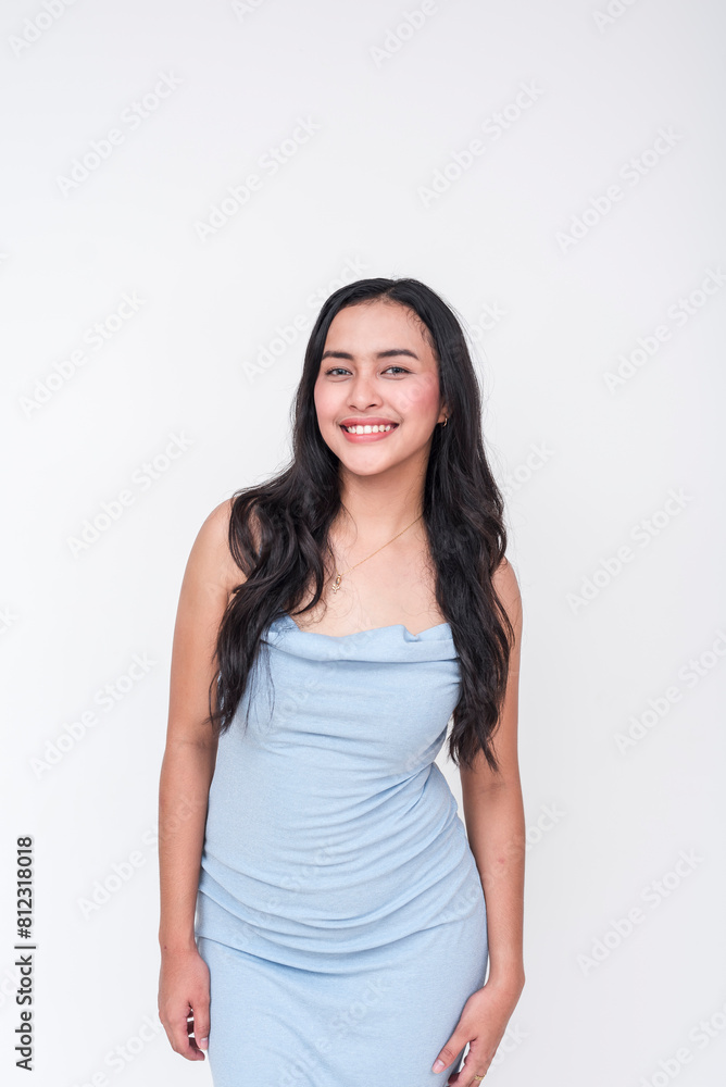 A cheerful young Asian woman wearing an elegant baby blue dress. Isolated on a clean white background, exuding a friendly vibe. A cheerful young Asian woman wearing an elegant baby blue dress. Isolated on a clean white background, exuding a friendly vibe.