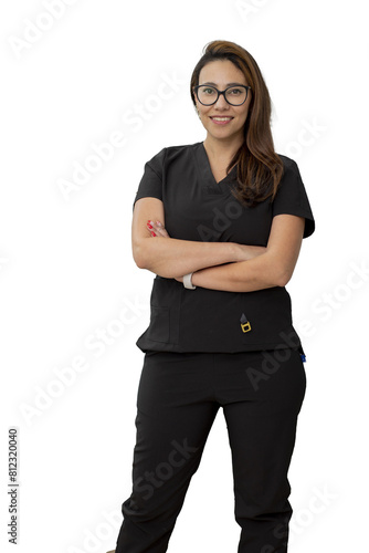 Dentist standing smiling and looking at the camera, in his medical office.