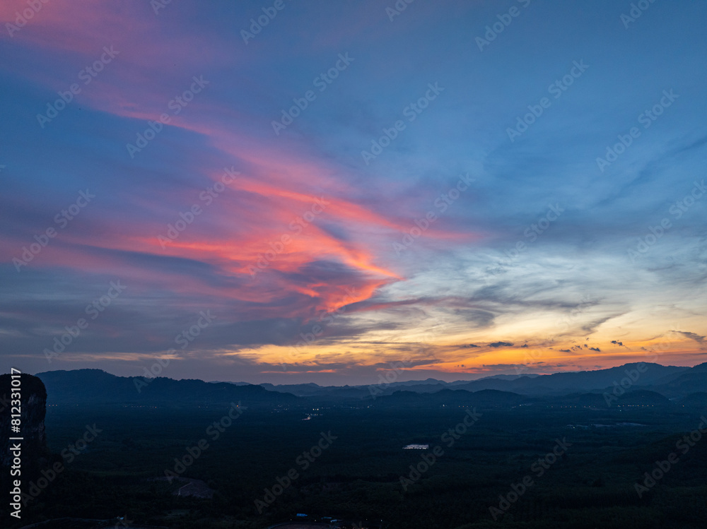 aerial view Beautiful pink cloud at sunset above mountain range in Phang Nga. .High peaks wonderful sunset natural Landscape. .Beautiful sunset tropical landscape background. aerial view Beautiful pink cloud at sunset above mountain range in Phang Nga. .High peaks wonderful sunset natural Landscape. .Beautiful sunset tropical landscape background.
