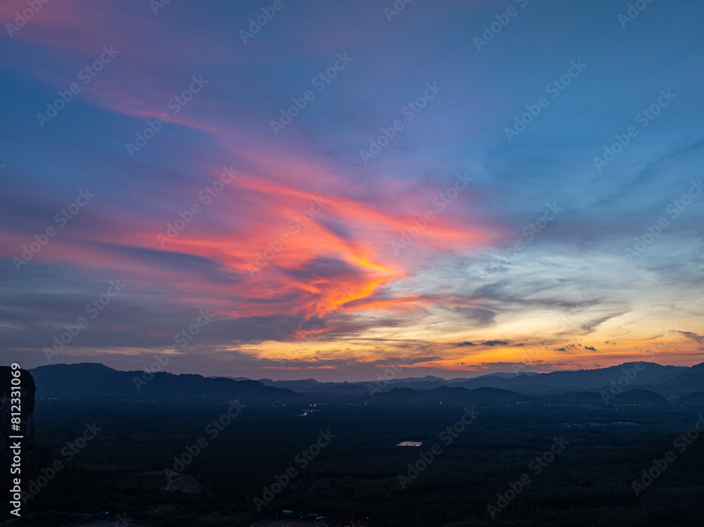 Naklejka premium aerial view Beautiful pink cloud at sunset above mountain range in Phang Nga. .High peaks wonderful sunset natural Landscape. .Beautiful sunset tropical landscape background.