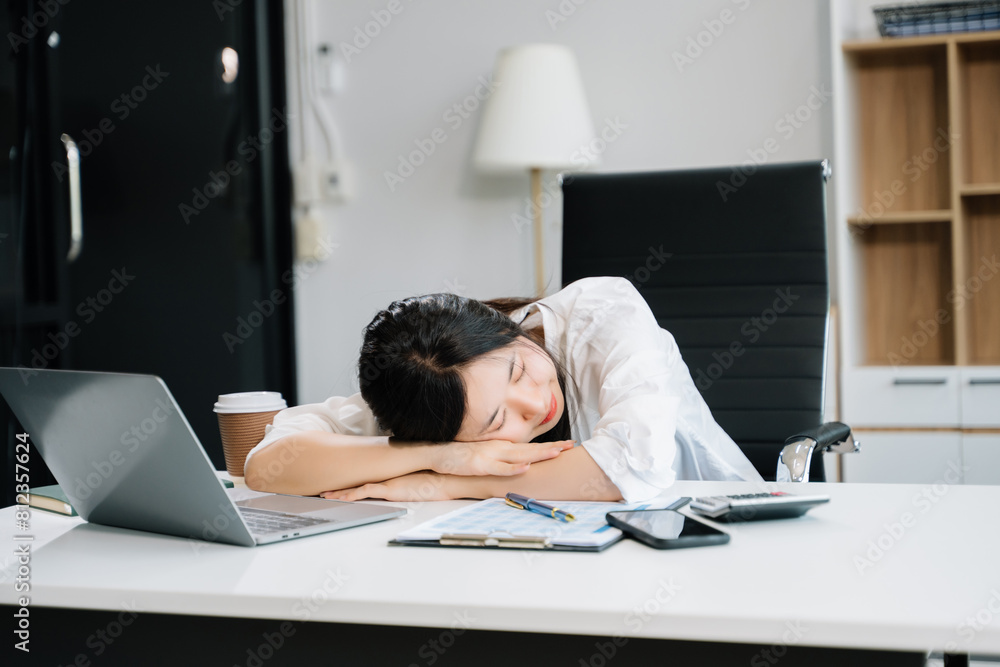 Asian business woman is stressed, bored, and overthinking from working on a tablet Asian business woman is stressed, bored, and overthinking from working on a tablet