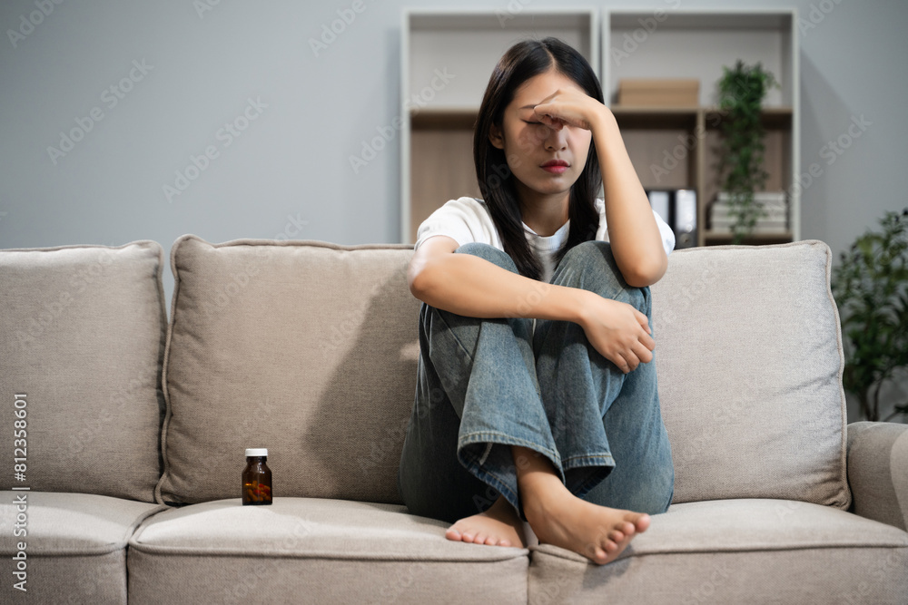 woman sit Depression Dark haired pensive glance Standing by window on sofa and anxiety woman sit Depression Dark haired pensive glance Standing by window on sofa and anxiety