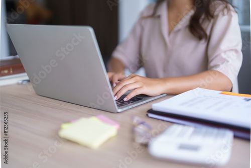 Young asian student in casual clothes watching tutorial and studying lecturer education online class while typing knowledge data and working homework with laptop digital technology in university