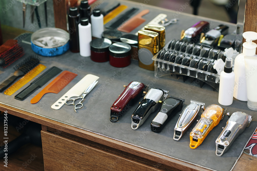 Set of clippers, combs and scissors on table on barber Set of clippers, combs and scissors on table on barber