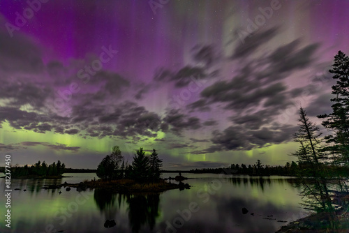 Northern Lights Dancing Over Tranquil Lake and Boreal Forest create an Etherial Aurora in Minnesota Northwoods near Duluth on Boulder Lake photo