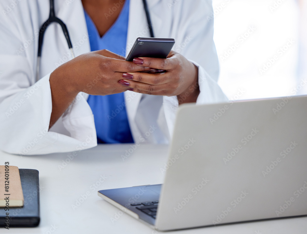 Female doctor, hands and smartphone with laptop at desk in office or workplace for medical research. Mobile, hospital and technology with texting or surgery schedule planning with app in Germany. Female doctor, hands and smartphone with laptop at desk in office or workplace for medical research. Mobile, hospital and technology with texting or surgery schedule planning with app in Germany.