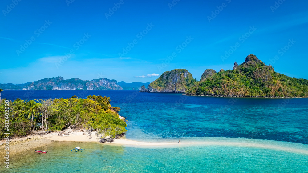 Aerail view of  tropical exotic island sand bar separating sea in two with turquoise  in El Nido, Palawan, Philippines.