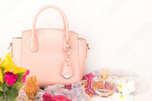 pink hand bag, perfume and scarf of lifestyle woman relax summer arrangement flat lay style on background white 