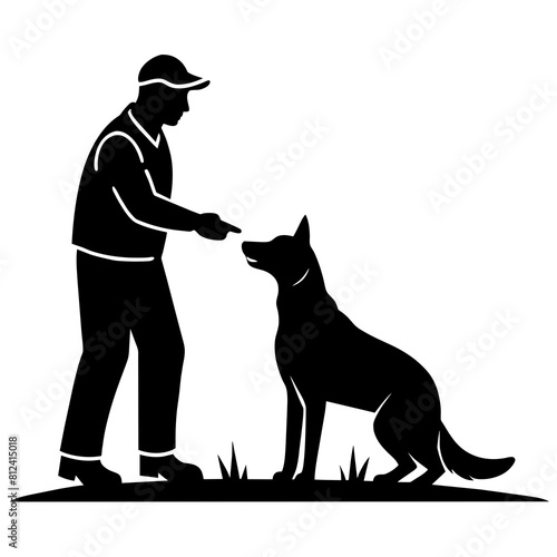 A dog trainer instructing a dog on a field silhouette
