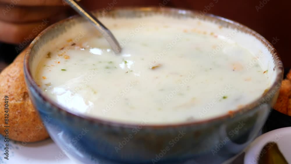 woman eating yogurt soup, traditional soup with chickpeas and mint. woman eating yogurt soup, traditional soup with chickpeas and mint.