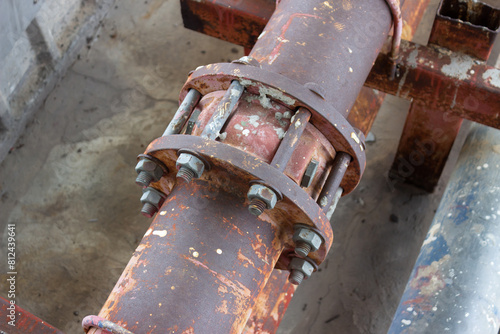 Rust corrosion flange and bolt on the old steel water pipeline distribution.Grunge rusted metal texture. Rusty corrosion and oxidized background.iron pipes, iron pipe joints, clean water pipes