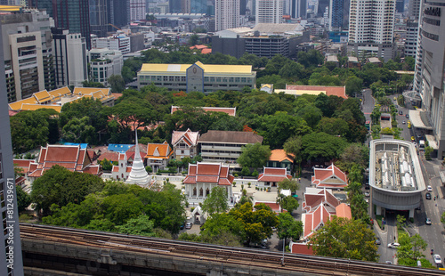 temple and height building for business stand in the heart of Bangkok,Thailand. Many hotel,Temple in the heart of Bangkok,Wat Pathum Wanaram