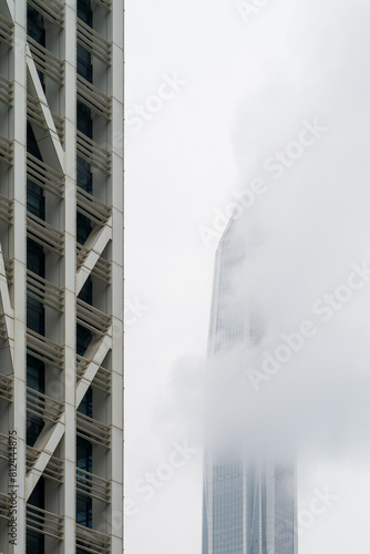Skyscrapers obscured by clouds and fog.