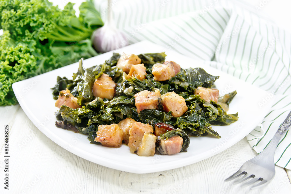 Kale cabbage with bacon in plate on board Kale cabbage with bacon in plate on board
