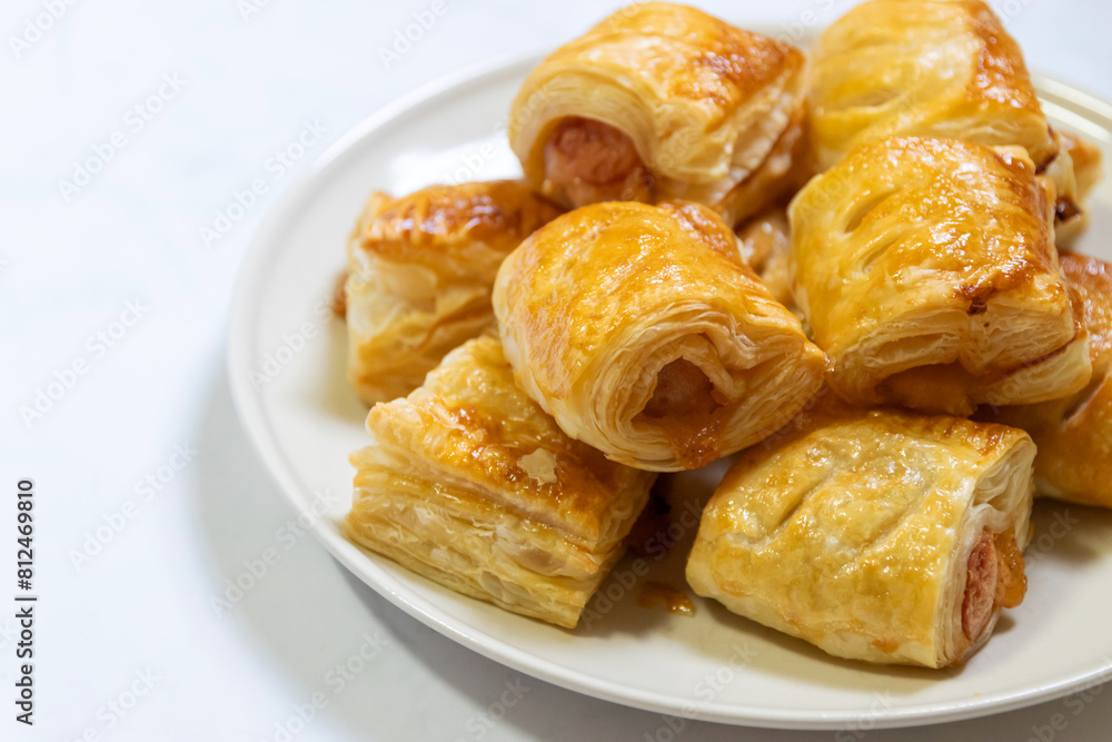 Homemade mini sausage puff pastry on plate. Homemade mini sausage puff pastry on plate.