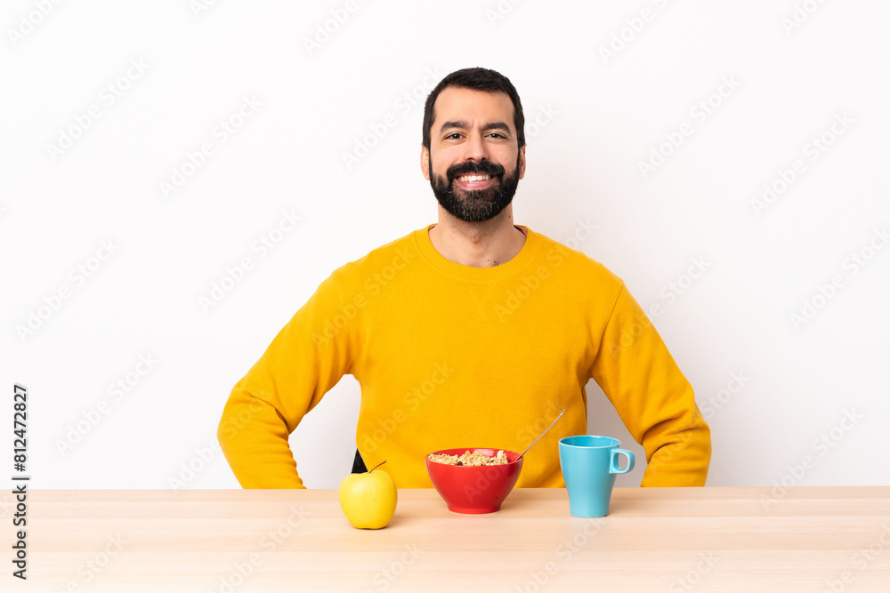 Caucasian man having breakfast in a table laughing. Caucasian man having breakfast in a table laughing.