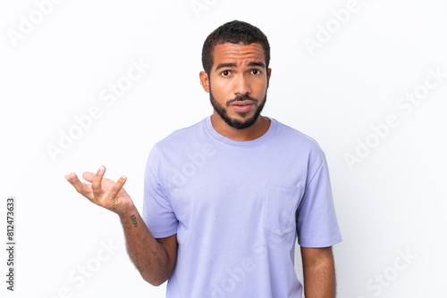Young Ecuadorian man isolated on white background making doubts gesture