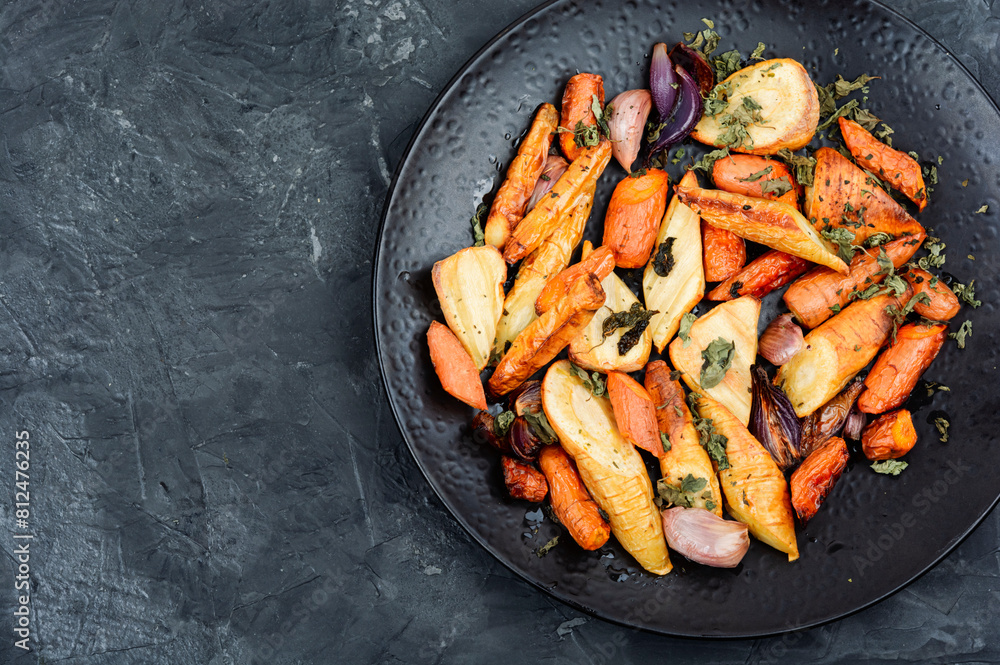 Roasted parsnip root and carrots. Roasted parsnip root and carrots.