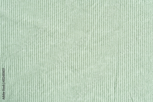 Clothing fabric green texture background, close up of cloth textile surface abstract.